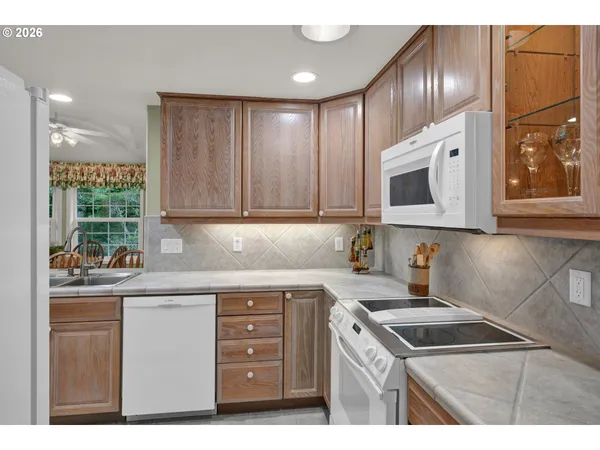 a kitchen with a sink a microwave and cabinets
