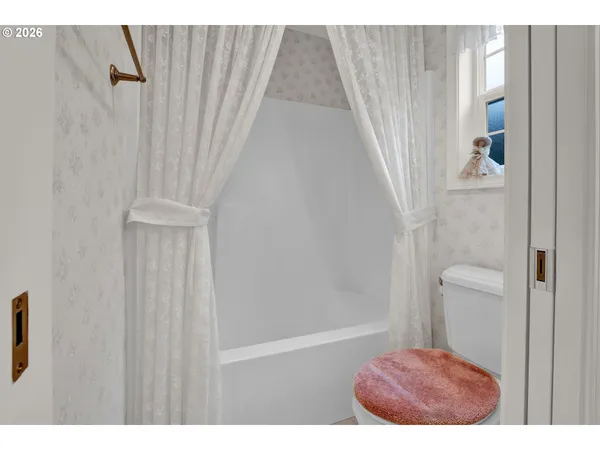 a picture of a bathroom with a shower curtain