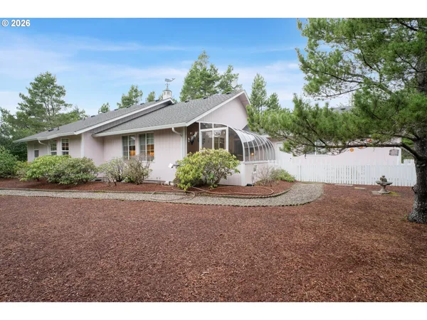 a view of a house with a yard and a garage