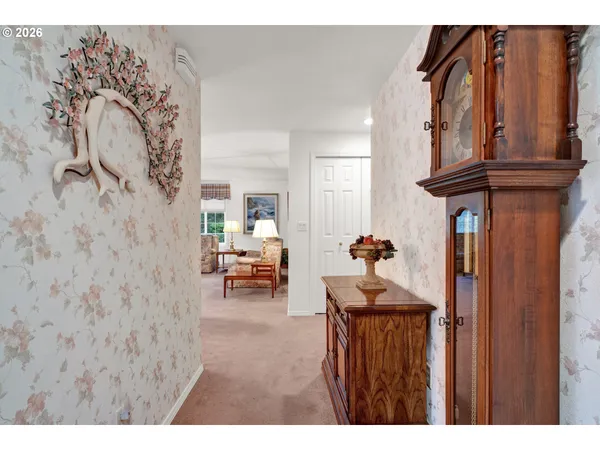 a view of a hallway with couches and painted walls