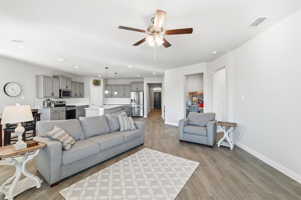 317 Hogan Drive Denton, TX 76210 - Photo 13 of 30 a living room with furniture and kitchen view