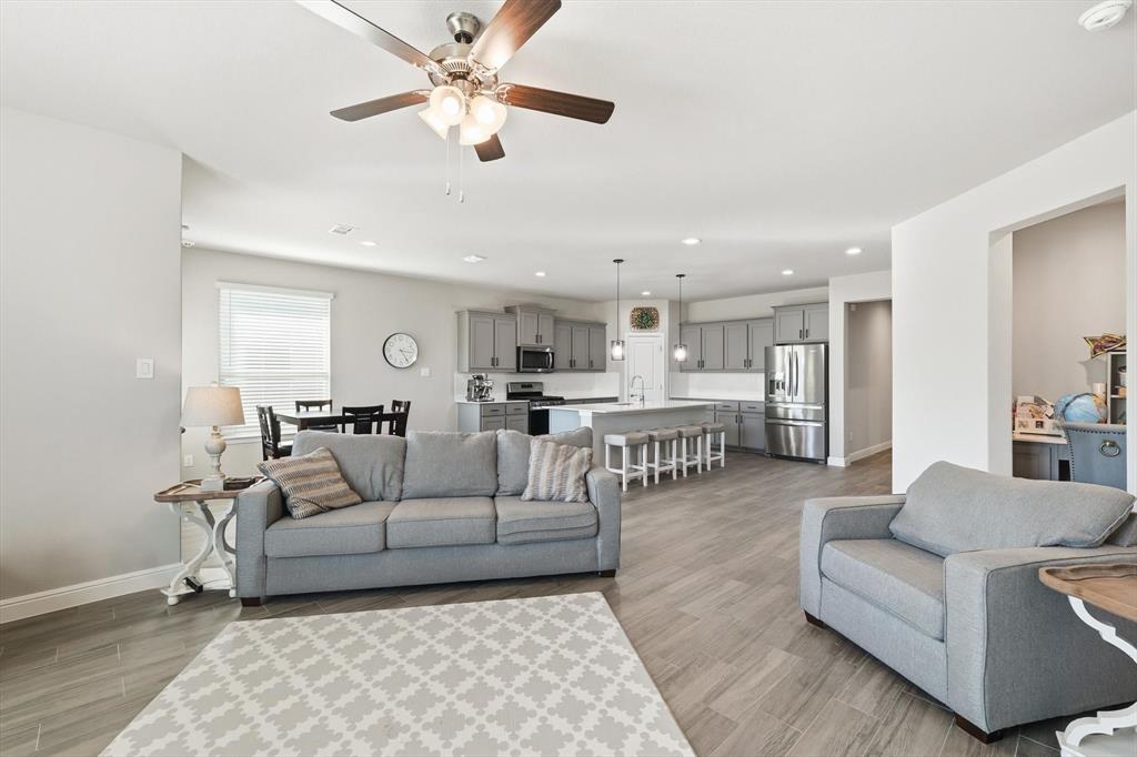 317 Hogan Drive Denton, TX 76210 - Photo 14 of 30 a living room with furniture and a view of kitchen