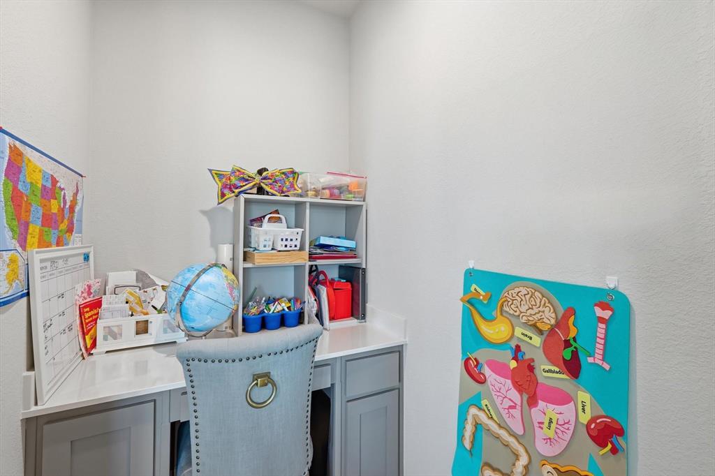 317 Hogan Drive Denton, TX 76210 - Photo 15 of 30 a utility room with toys and a book shelf