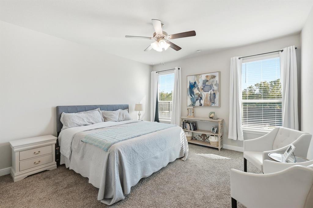 317 Hogan Drive Denton, TX 76210 - Photo 16 of 30 a spacious bedroom with a bed and a couch