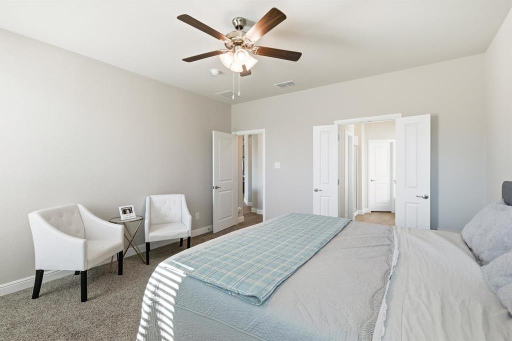317 Hogan Drive Denton, TX 76210 - Photo 17 of 30 a bedroom with a bed and chair