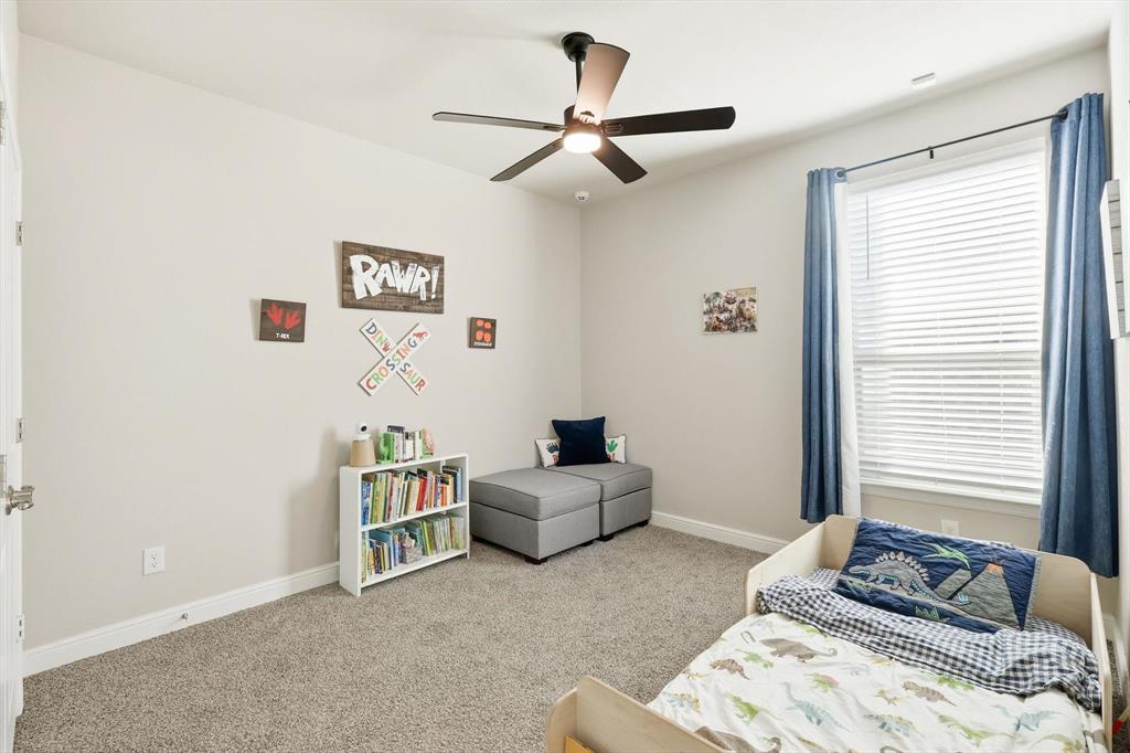 317 Hogan Drive Denton, TX 76210 - Photo 26 of 30 a bedroom with a bed and a window