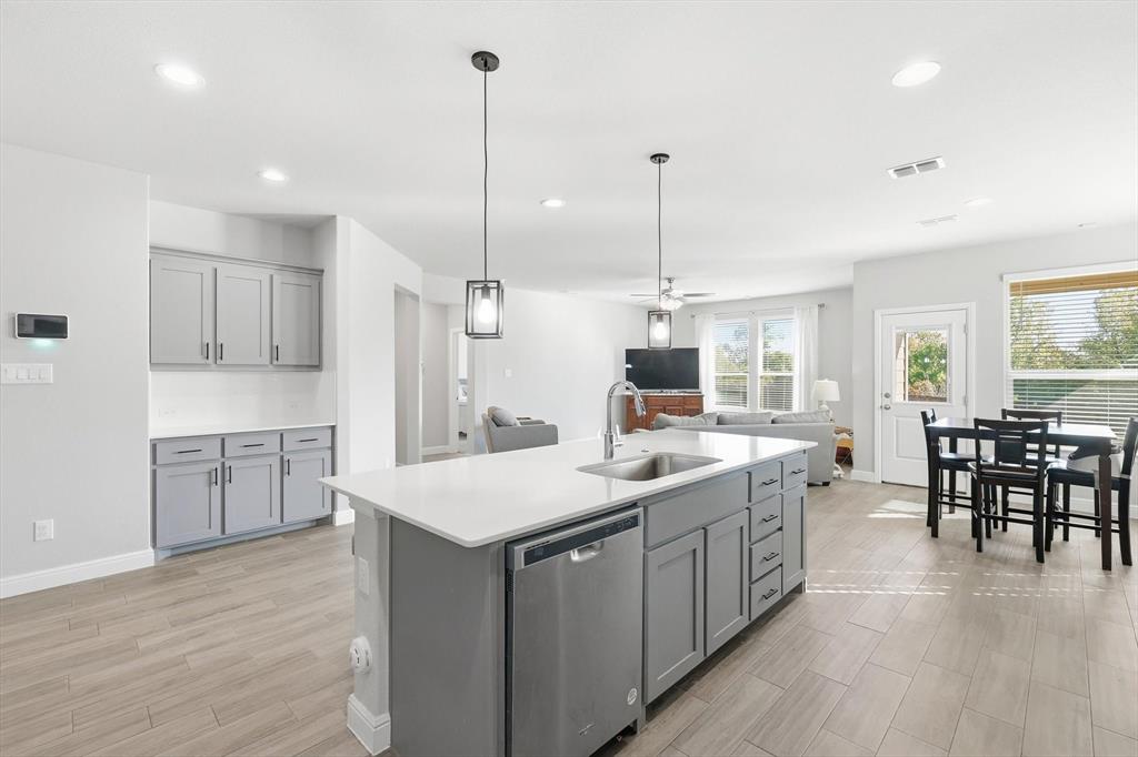 317 Hogan Drive Denton, TX 76210 - Photo 8 of 30 a large kitchen with lots of counter space a sink appliances and living room view