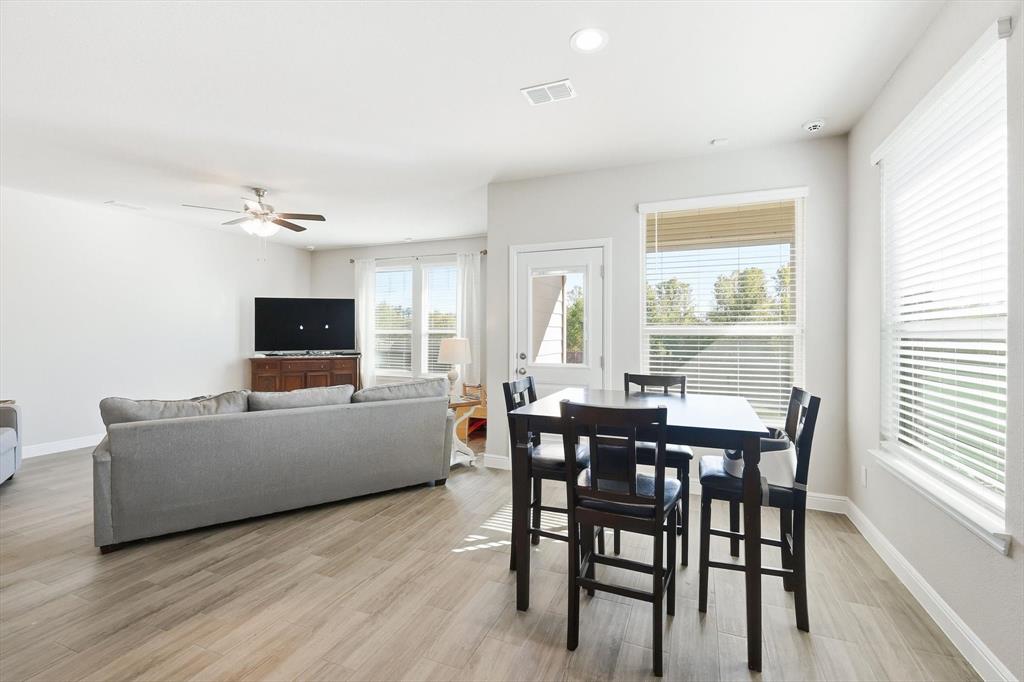 317 Hogan Drive Denton, TX 76210 - Photo 10 of 30 a living room with furniture a flat screen tv and a large window