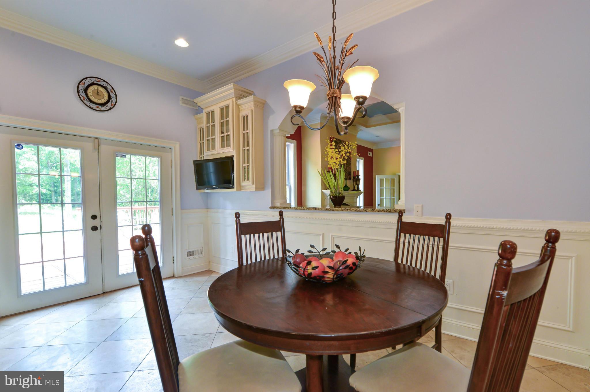8130 Stacey Road Alexandria, VA 22308 - Photo 3 of 30 a view of a dining room with furniture wooden floor and chandelier