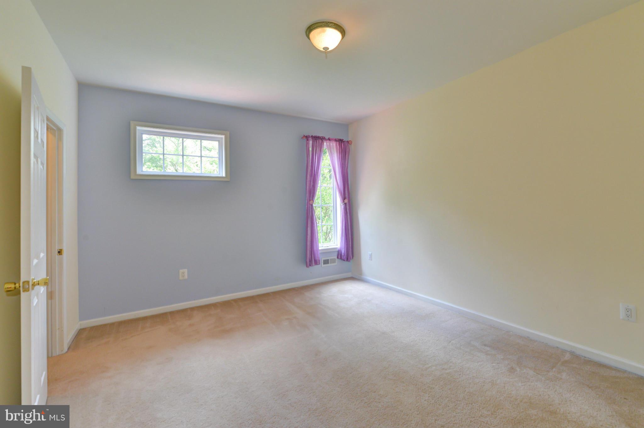 8130 Stacey Road Alexandria, VA 22308 - Photo 22 of 30 an empty room with windows and painted walls
