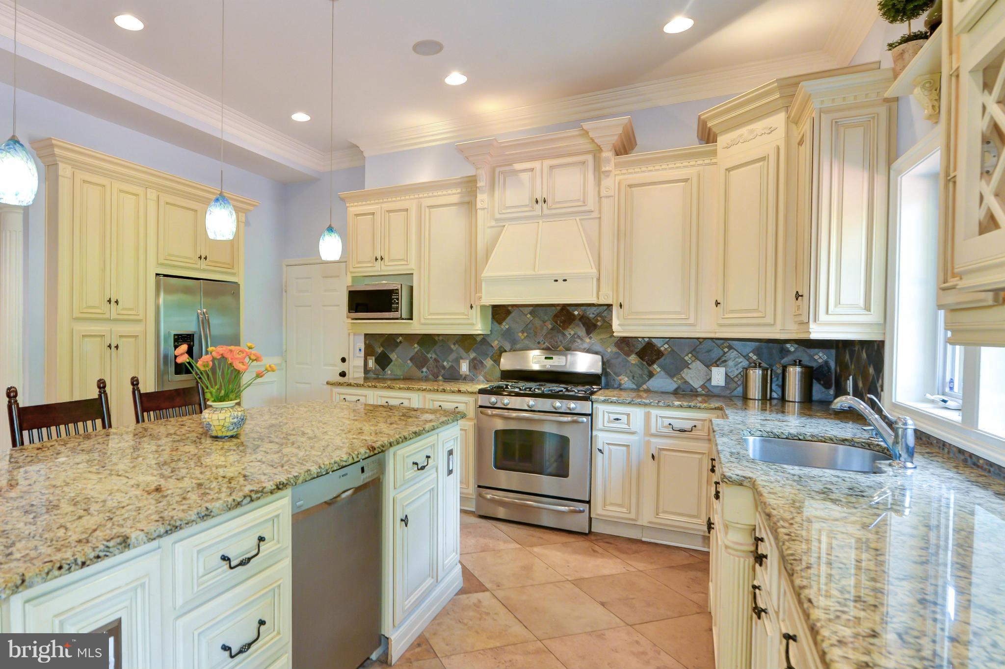 8130 Stacey Road Alexandria, VA 22308 - Photo 8 of 30 a kitchen with stainless steel appliances granite countertop a sink a stove and cabinets
