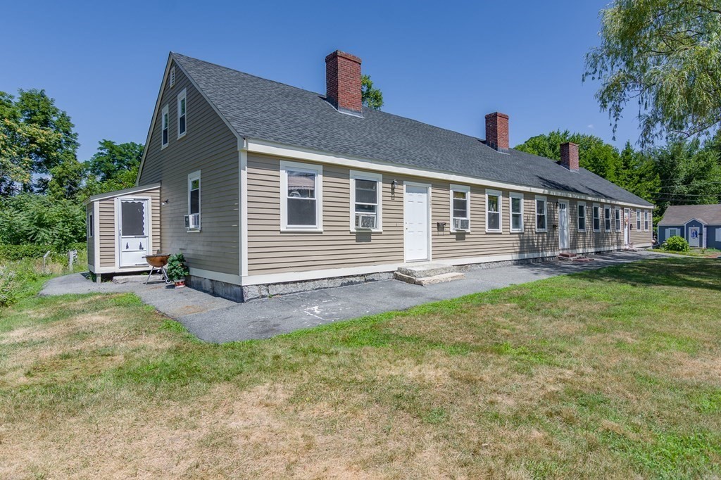 139 Baldwin Street Lowell, MA 01851 - Photo 1 of 39 a front view of a house with a yard