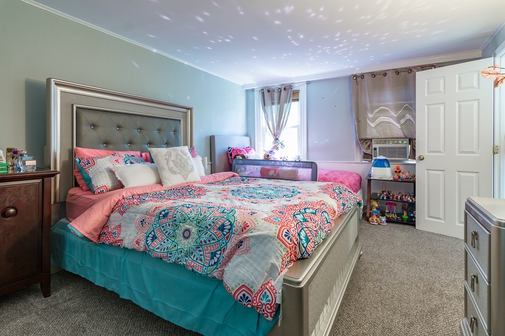 139 Baldwin Street Lowell, MA 01851 - Photo 11 of 39 a bedroom with a bed and a window