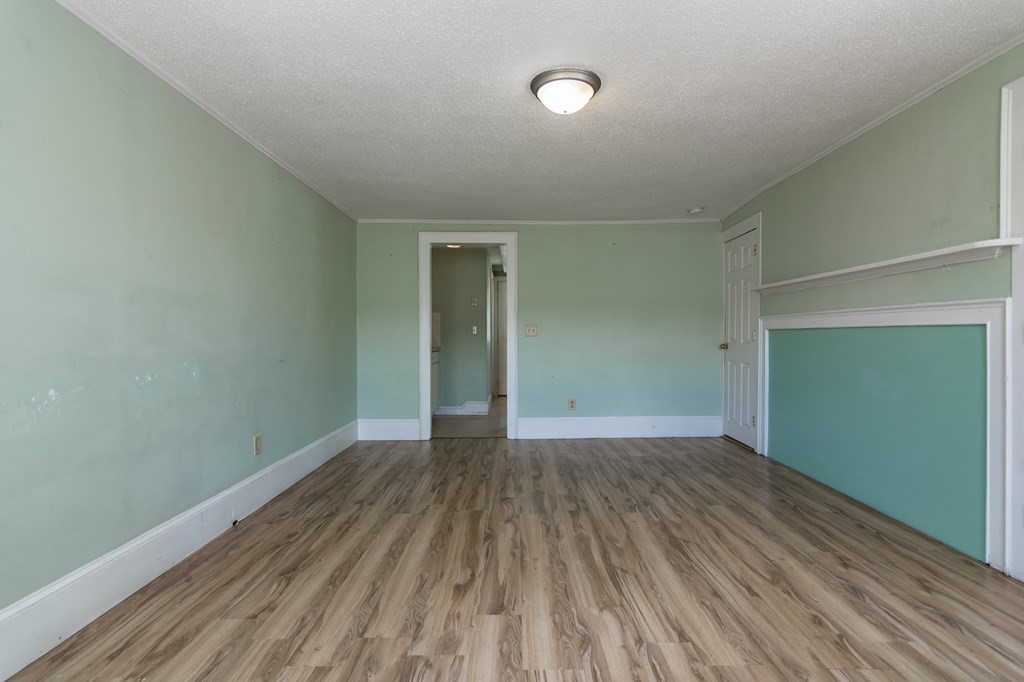 139 Baldwin Street Lowell, MA 01851 - Photo 14 of 39 an empty room with wooden floor and closet
