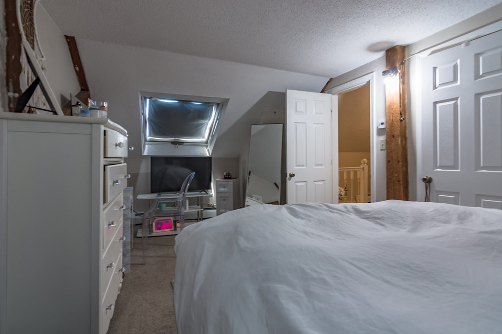 139 Baldwin Street Lowell, MA 01851 - Photo 24 of 39 a bed room with a bed and a television
