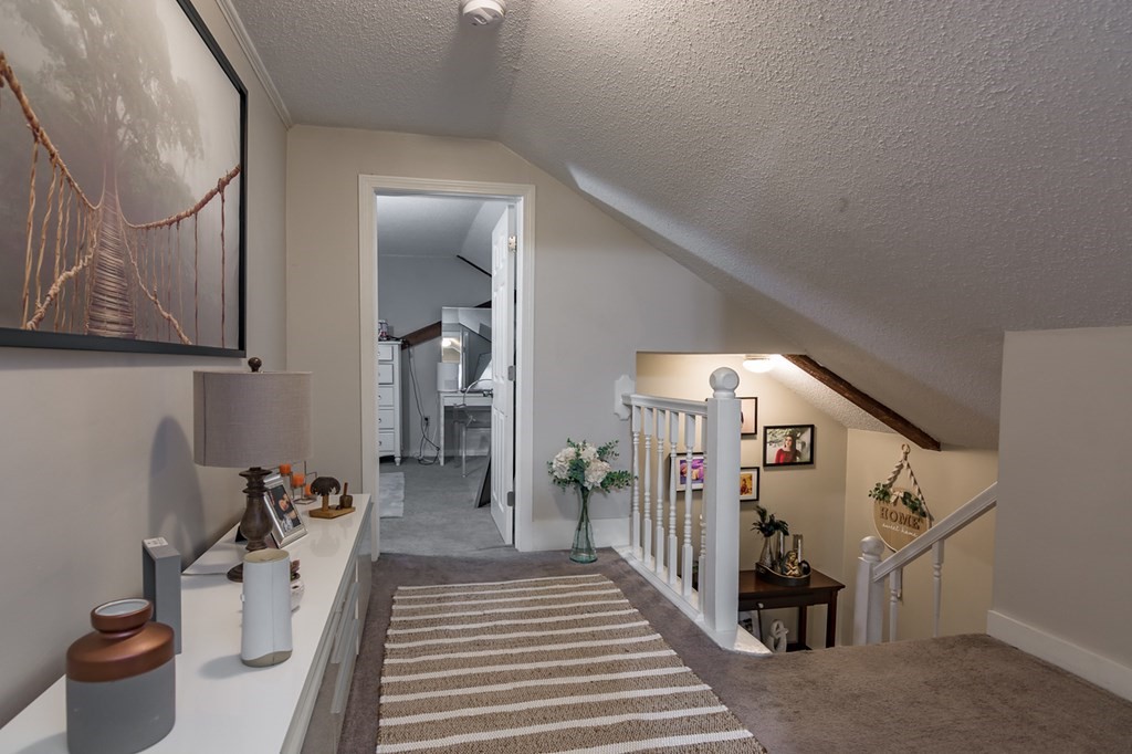 139 Baldwin Street Lowell, MA 01851 - Photo 26 of 39 a view of a hallway with paintings on the wall
