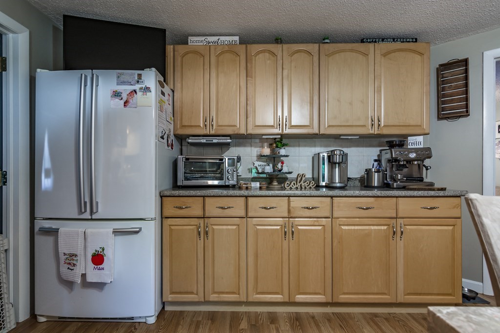 139 Baldwin Street Lowell, MA 01851 - Photo 31 of 39 a kitchen with stainless steel appliances granite countertop a refrigerator and a stove