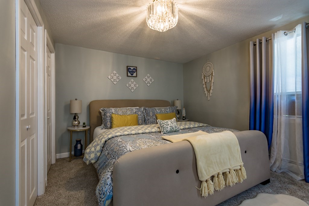 139 Baldwin Street Lowell, MA 01851 - Photo 38 of 39 a bedroom with a bed and a chandelier