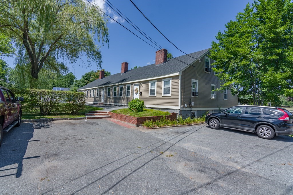 139 Baldwin Street Lowell, MA 01851 - Photo 4 of 39 front view of a house with a yard