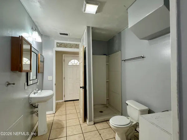 a bathroom with a toilet sink and shower