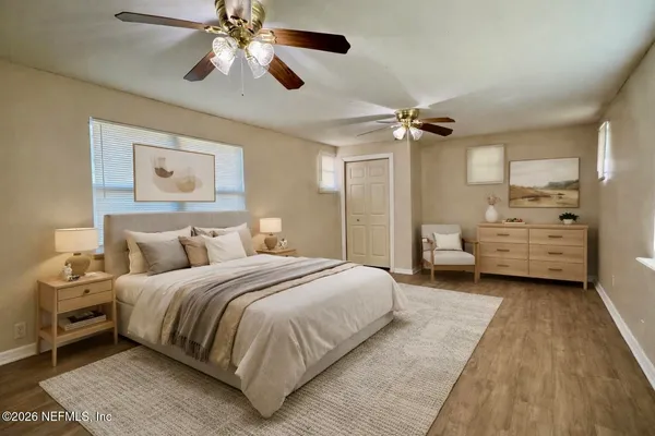 a bedroom with bed and a chandelier
