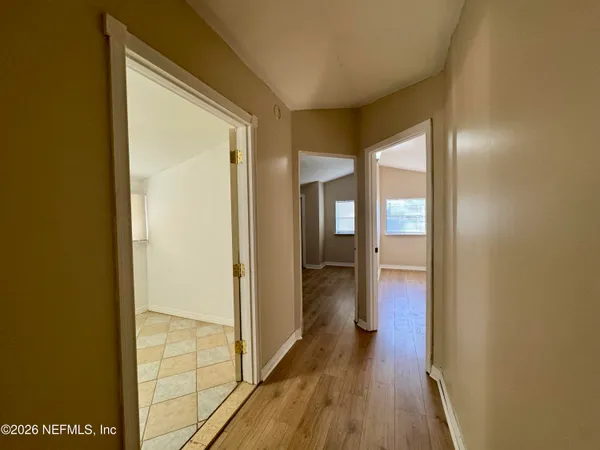 a view of a hallway with wooden floor