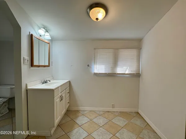 a bathroom with a sink and mirror