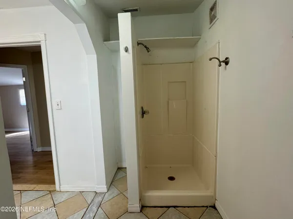 a bathroom with a glass shower door