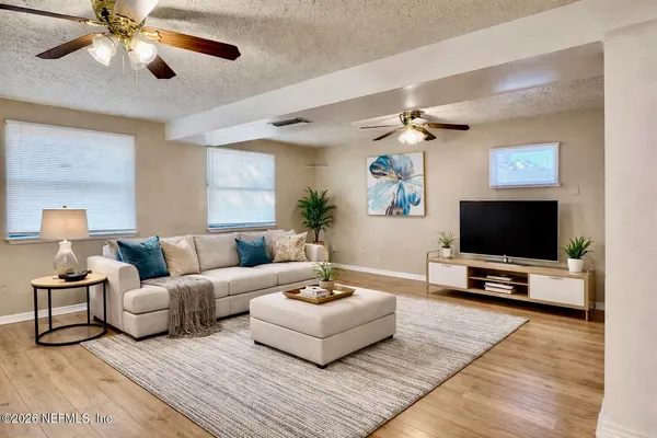 a living room with furniture and a flat screen tv