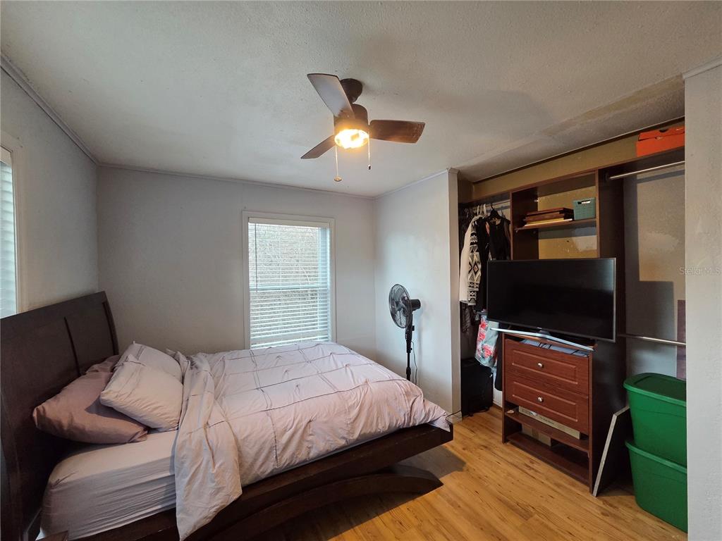 124 East F Street Frostproof, FL 33843 - Photo 17 of 37 a bedroom with bed and a flat tv screen on a dresser
