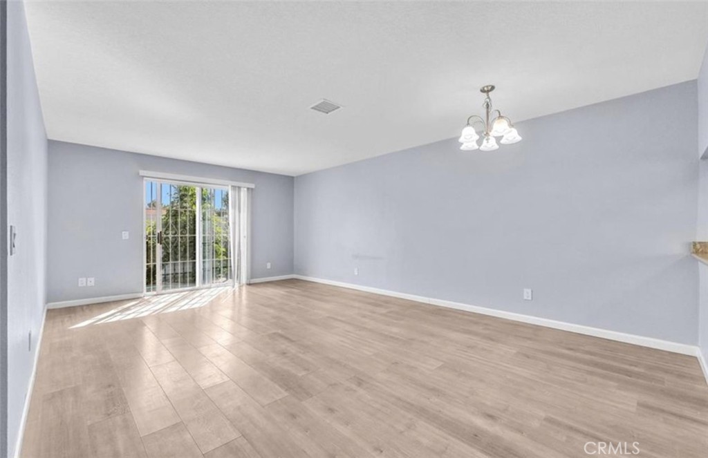 3738 Harrison Street, Unit 31 Riverside, CA 92503 - Photo 12 of 25 a view of an empty room with a window and wooden floor