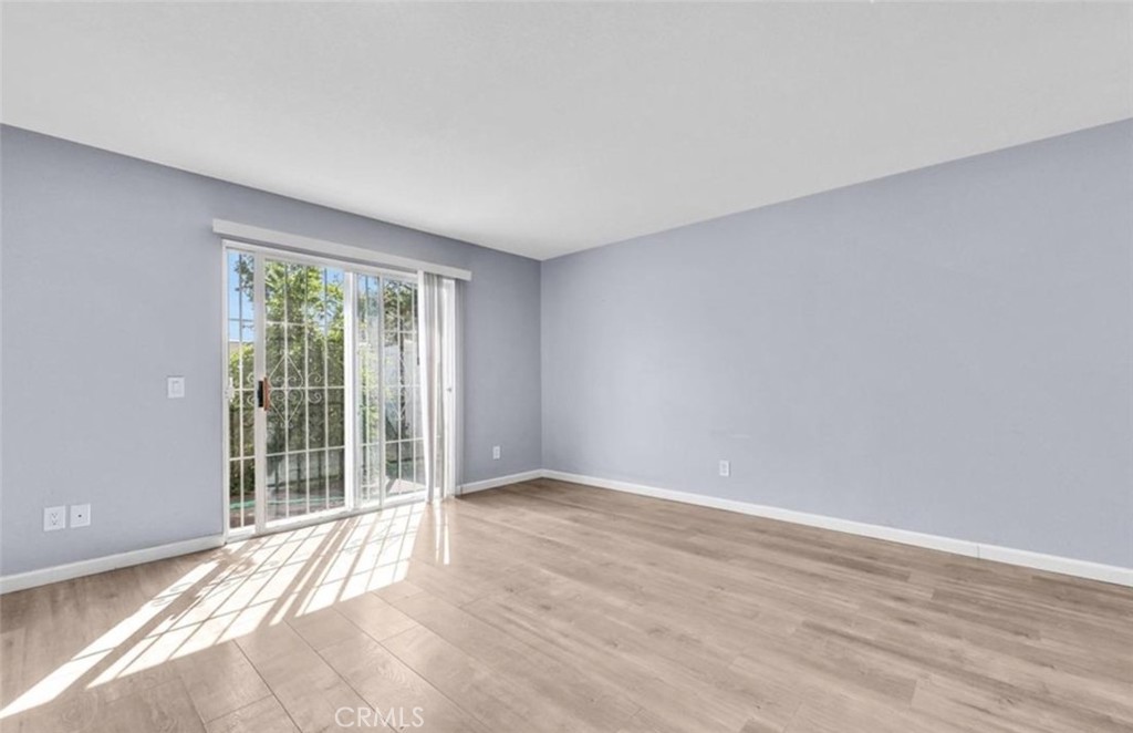 3738 Harrison Street, Unit 31 Riverside, CA 92503 - Photo 13 of 25 a view of an empty room with wooden floor and a window