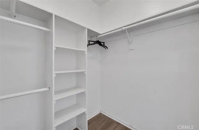 a view of walk in closet with empty racks