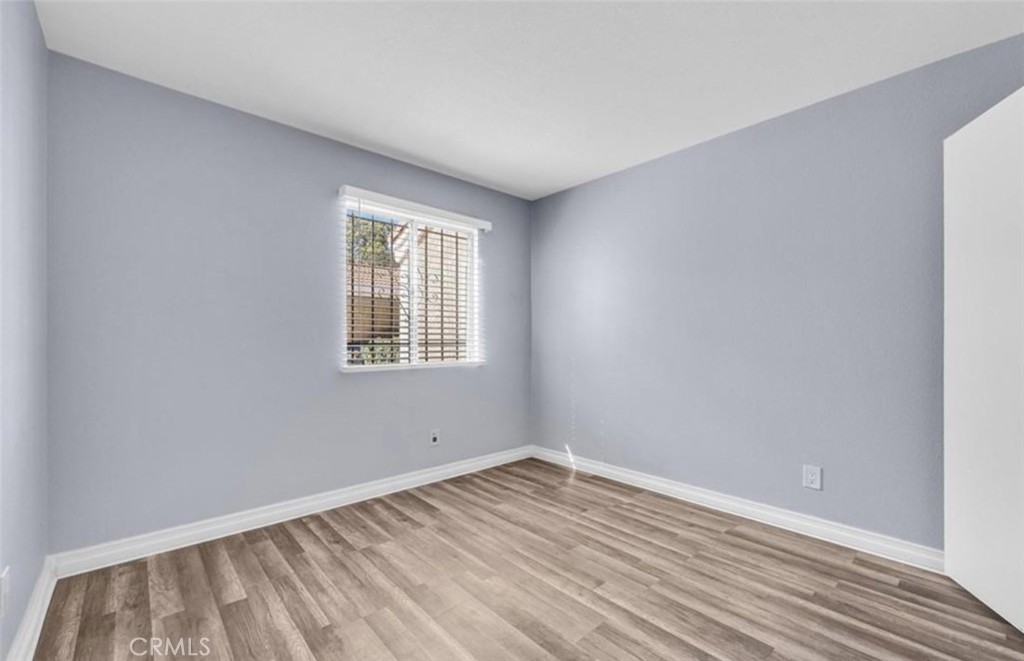 3738 Harrison Street, Unit 31 Riverside, CA 92503 - Photo 18 of 25 an empty room with wooden floor and windows
