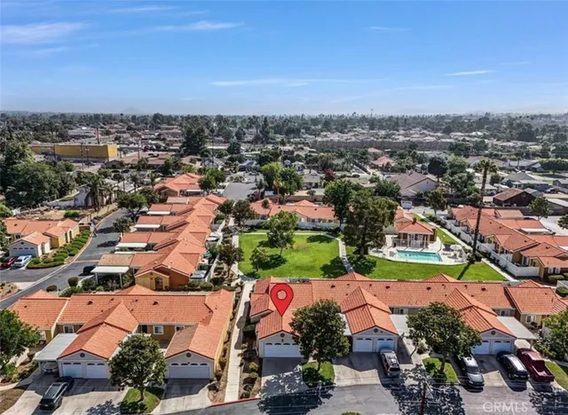 an aerial view of residential houses with outdoor space