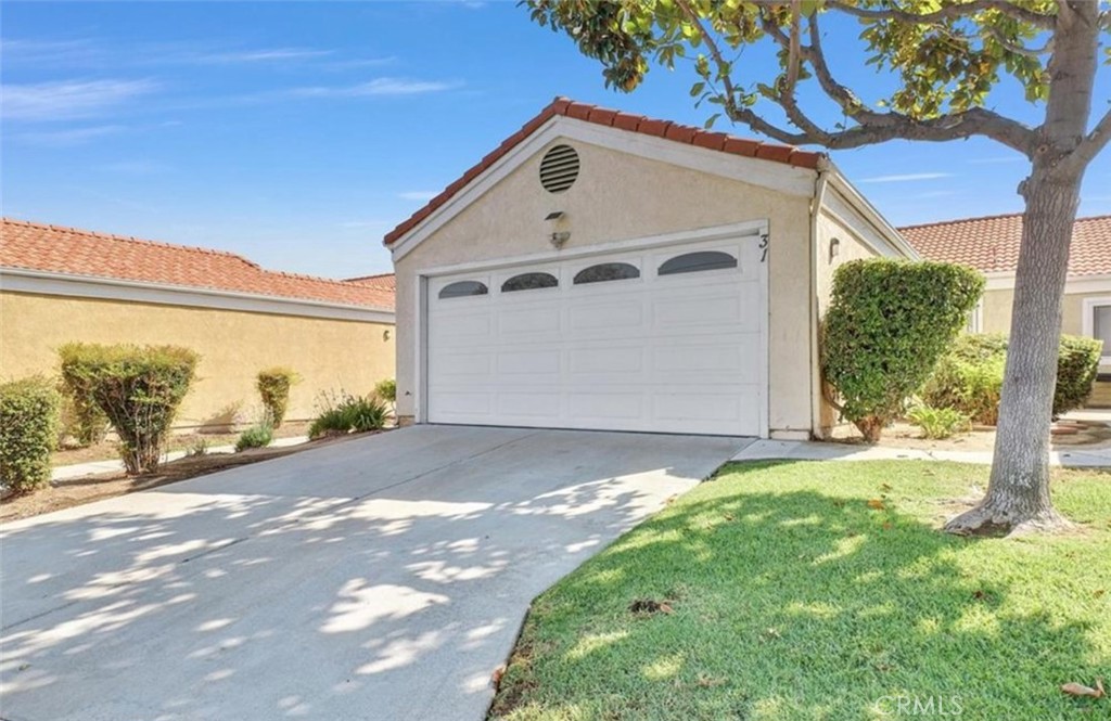 3738 Harrison Street, Unit 31 Riverside, CA 92503 - Photo 3 of 25 a front view of a house with a yard