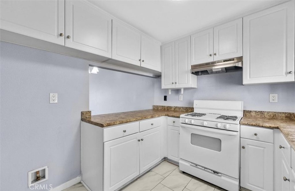 3738 Harrison Street, Unit 31 Riverside, CA 92503 - Photo 4 of 25 a kitchen with granite countertop white cabinets and white appliances