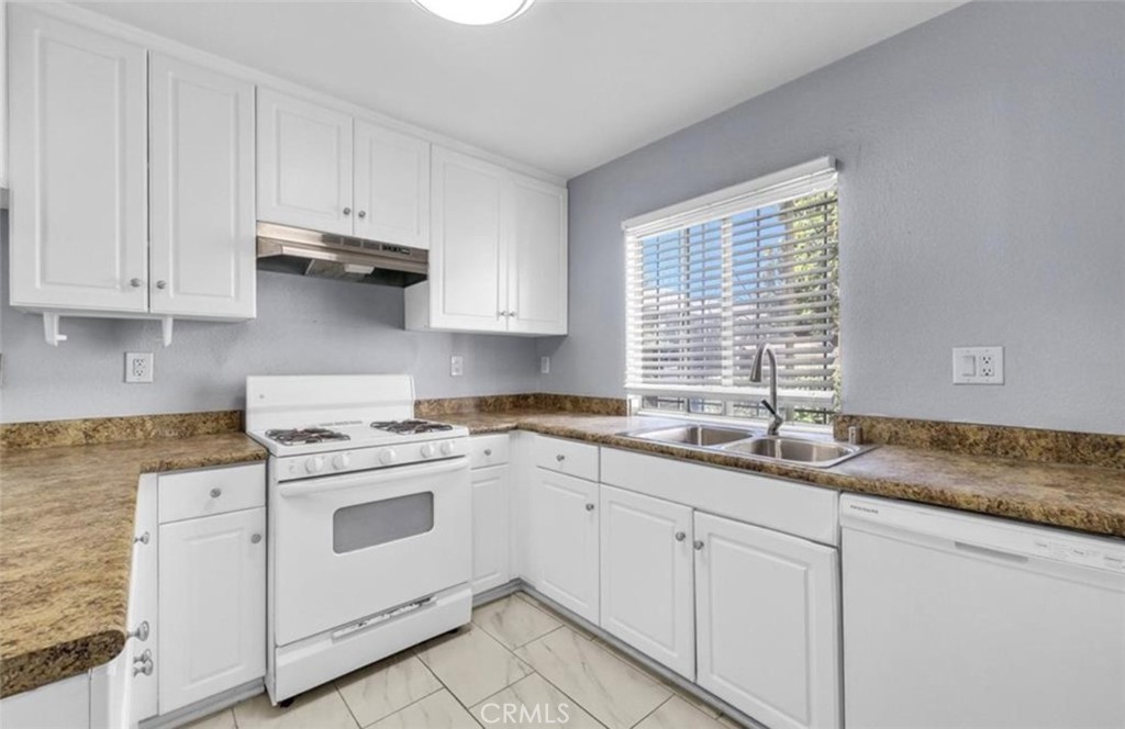 3738 Harrison Street, Unit 31 Riverside, CA 92503 - Photo 5 of 25 a kitchen with granite countertop white cabinets and white stainless steel appliances