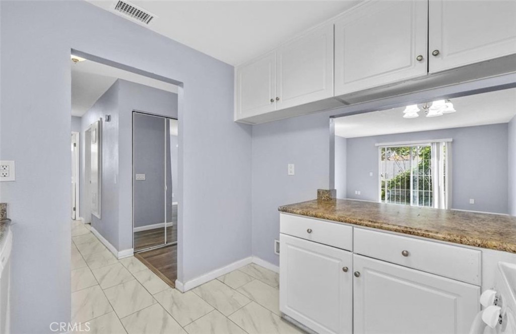 3738 Harrison Street, Unit 31 Riverside, CA 92503 - Photo 7 of 25 a kitchen with granite countertop cabinets and window