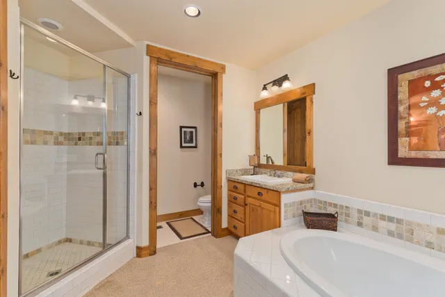 a bathroom with a double vanity sink mirror and shower