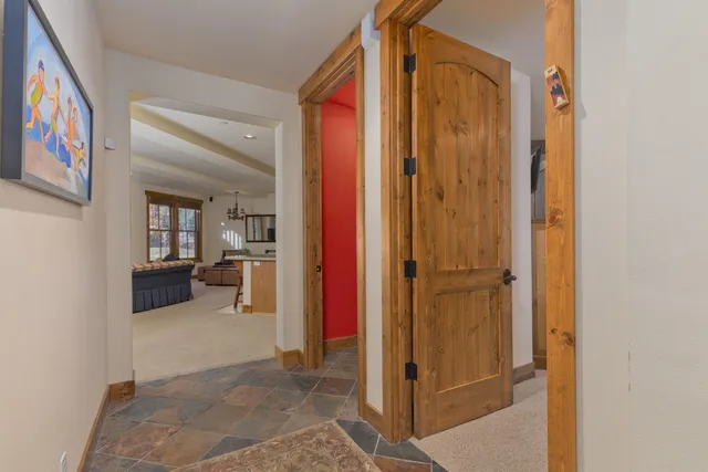 a view of elevator with hallway and wooden floor