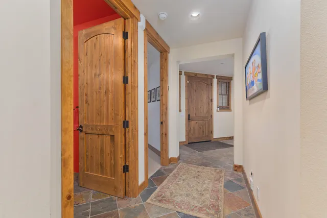 a view of a hallway with closet and bathroom