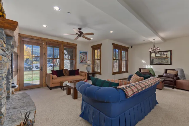 a living room with furniture ceiling fan and a rug