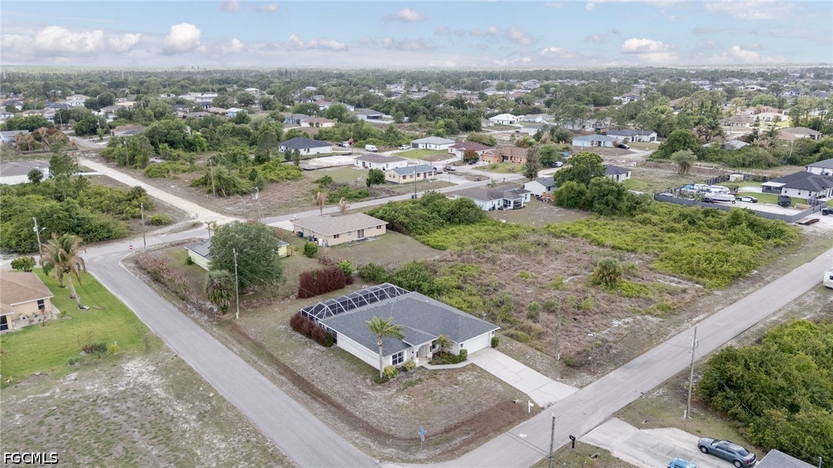 3801 28th Street Southwest Lehigh Acres, FL 33976 - Photo 30 of 37 an aerial view of residential houses with outdoor space and trees