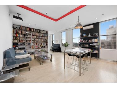 a living room with furniture a rug and white walls