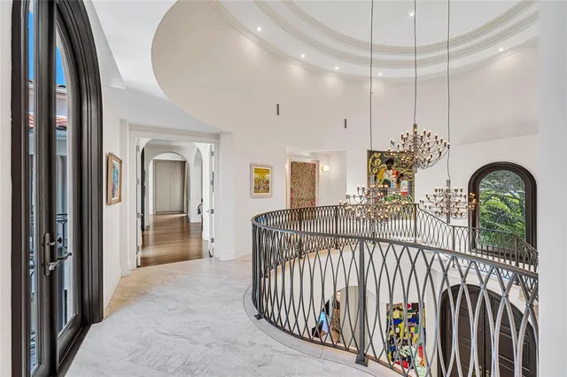 a view of a house with large windows and a table and chairs