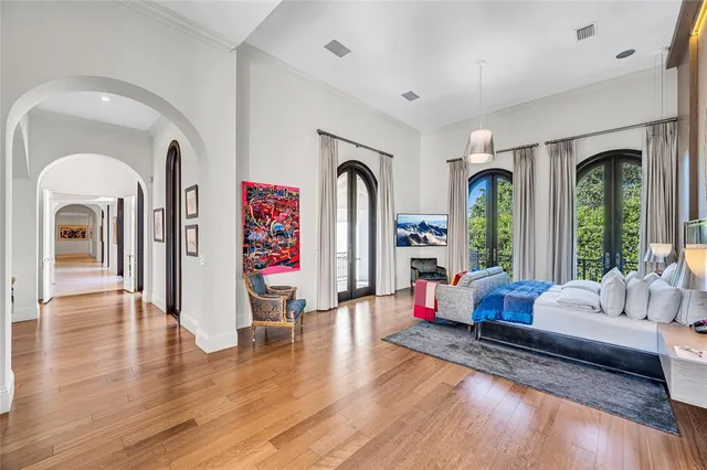 a bedroom with a bed mirror and window