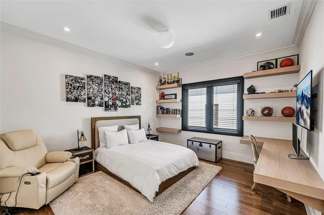 a front view of a house with a tree