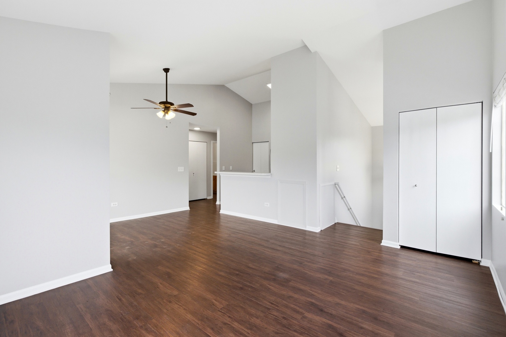 2023 Silverstone Drive, Unit 2023 Carpentersville, IL 60110 - Photo 3 of 19 an empty room with wooden floor and windows
