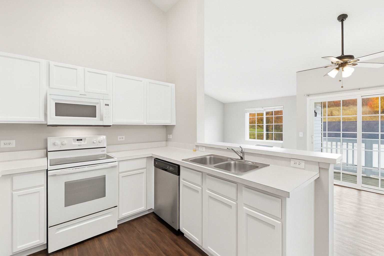 2023 Silverstone Drive, Unit 2023 Carpentersville, IL 60110 - Photo 8 of 19 a kitchen with granite countertop white cabinets white appliances and a sink